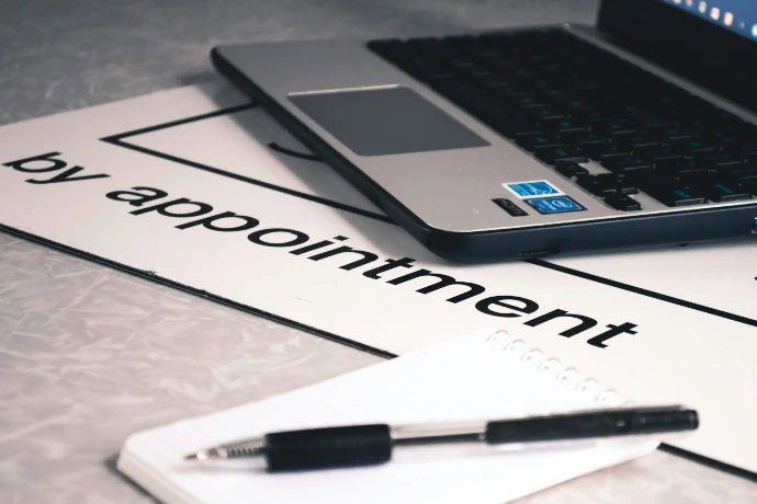 Online appointment booking concept with laptop and schedule planner