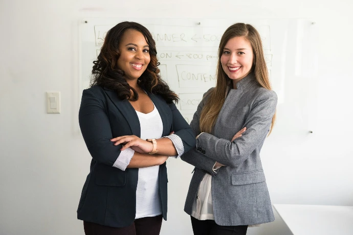 Professional cleaning team members standing confidently in office setting